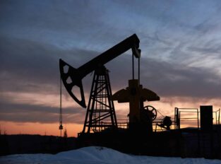 Beautiful sunset over oil field with pump jack.