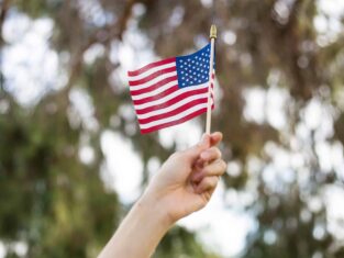 Hand waving an American fly outdoors