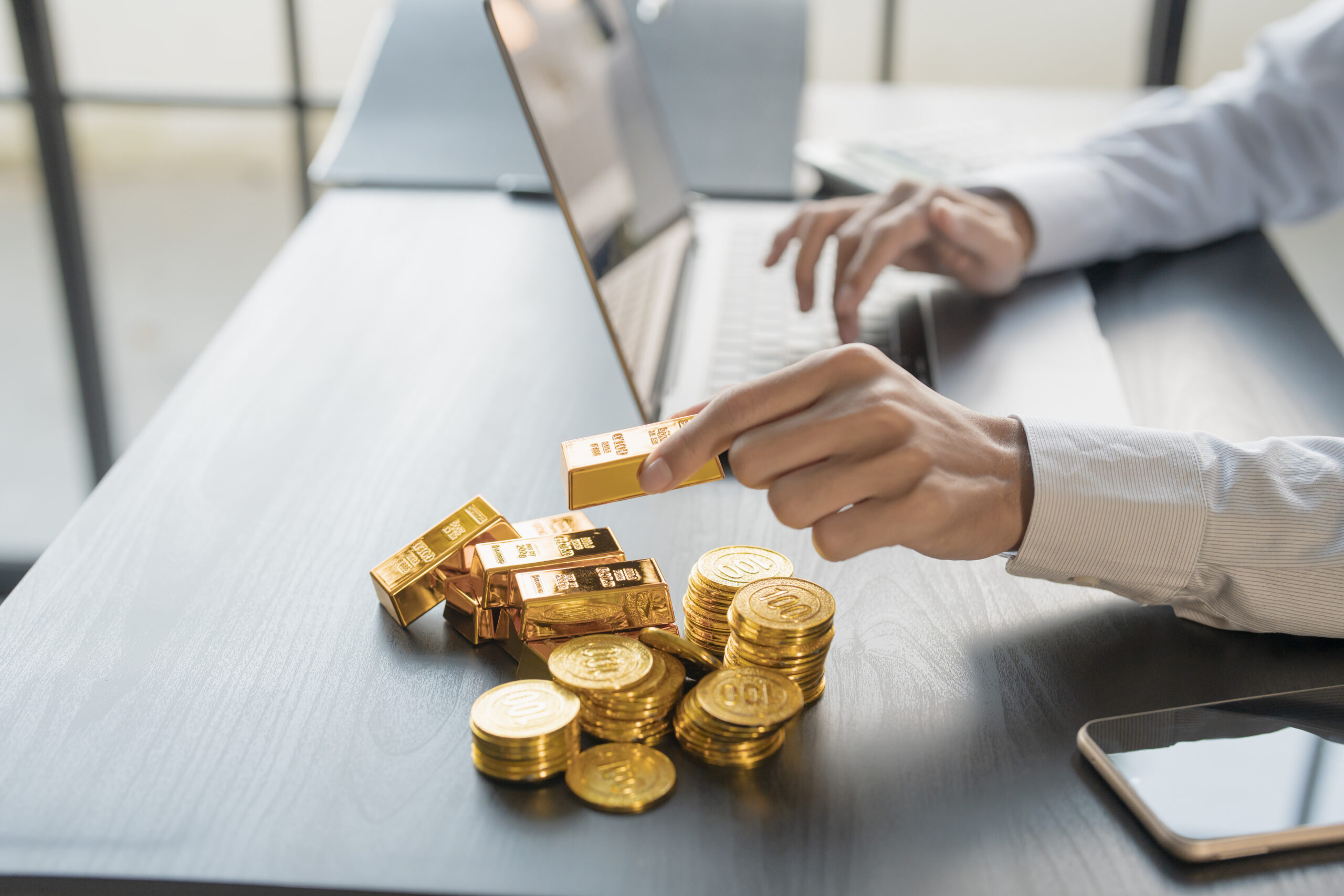 Gold Trading business man hand offering gold Investment in gold
